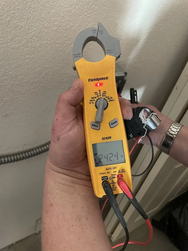 Voltage testing with clamp meter during Ceiling Fan Installation in Livingston